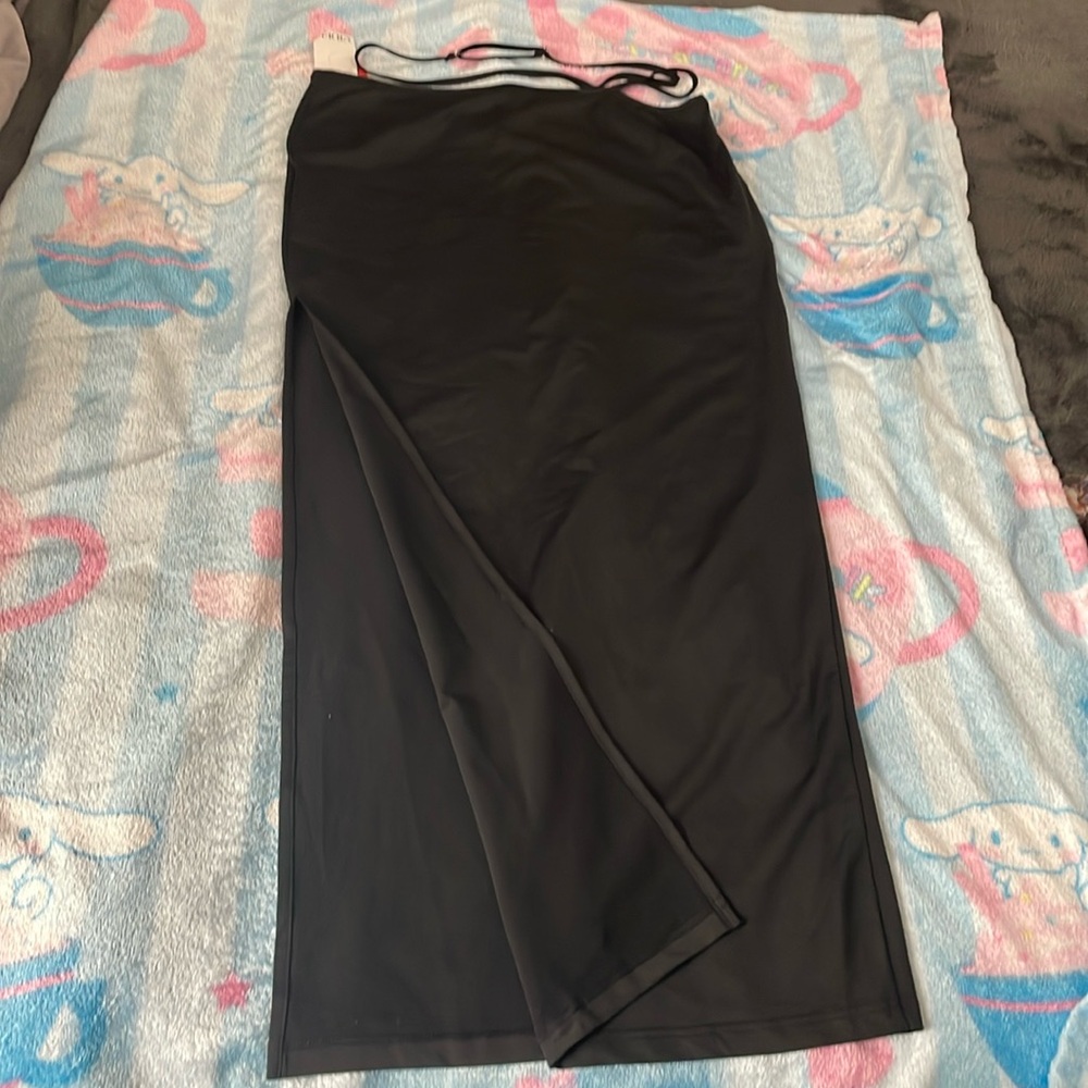 Long black skirt with band around the waist and slit